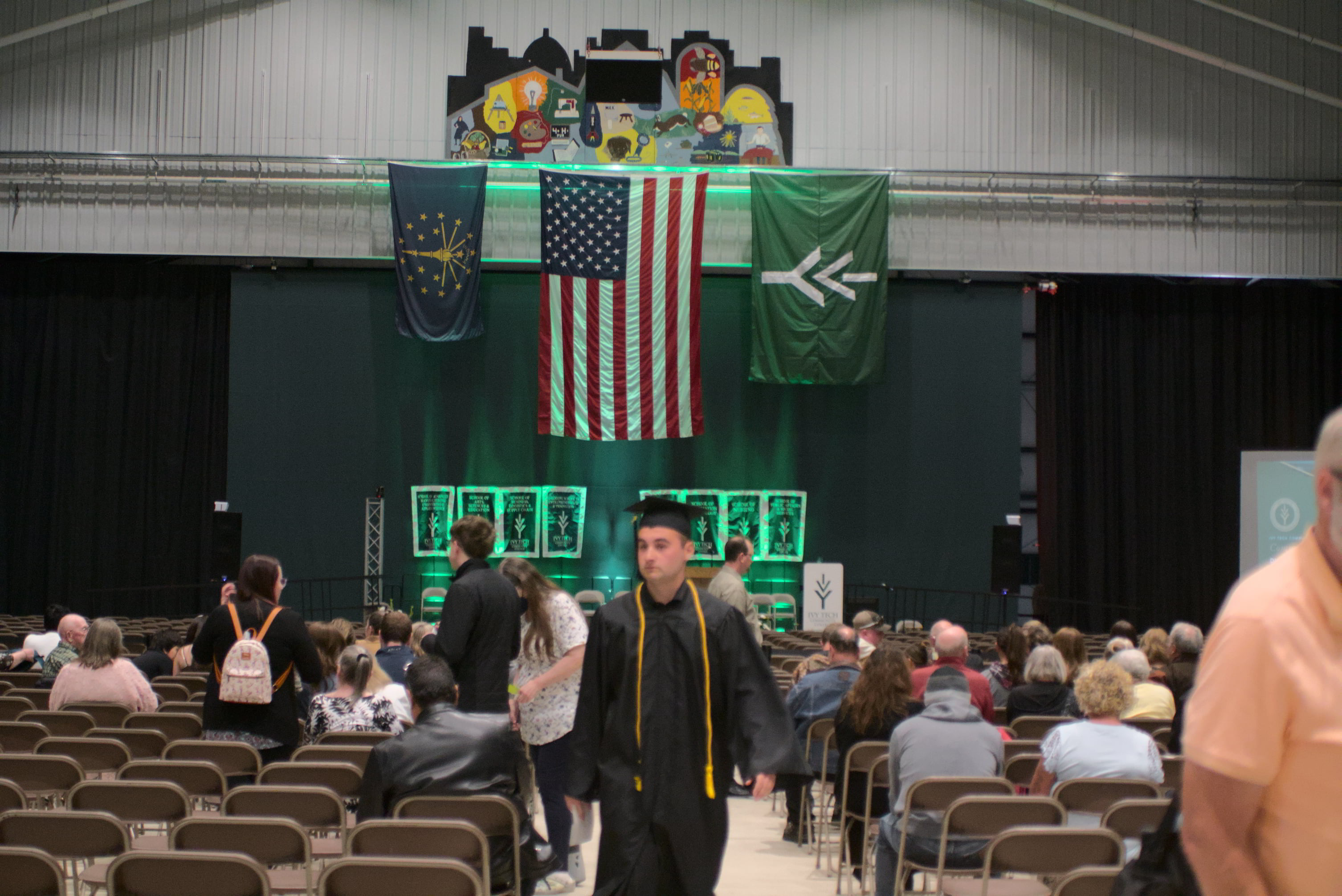 Graduation ceremony with green stage lighting
