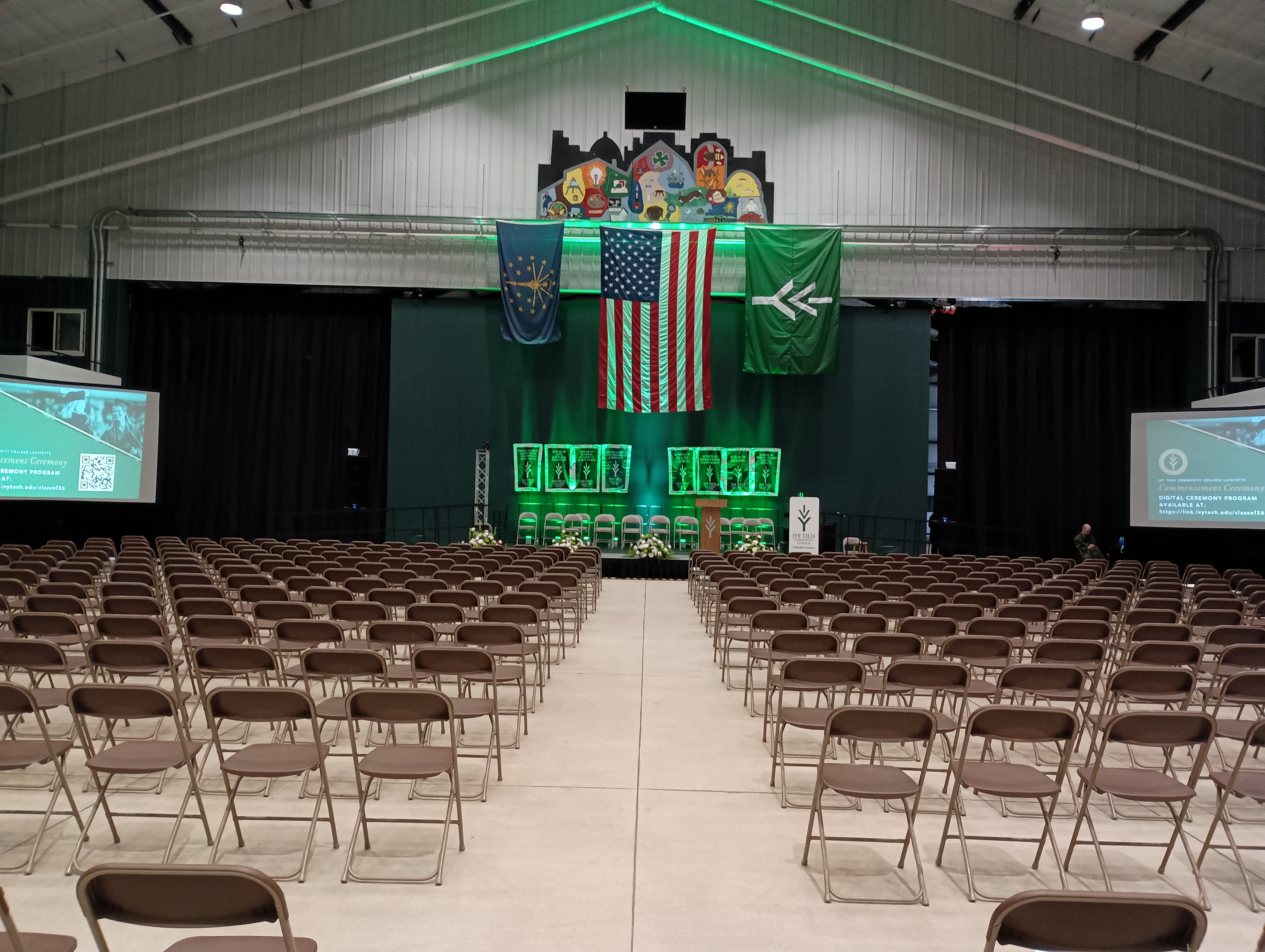 Empty venue staged and ready with rows of seating facing the stage