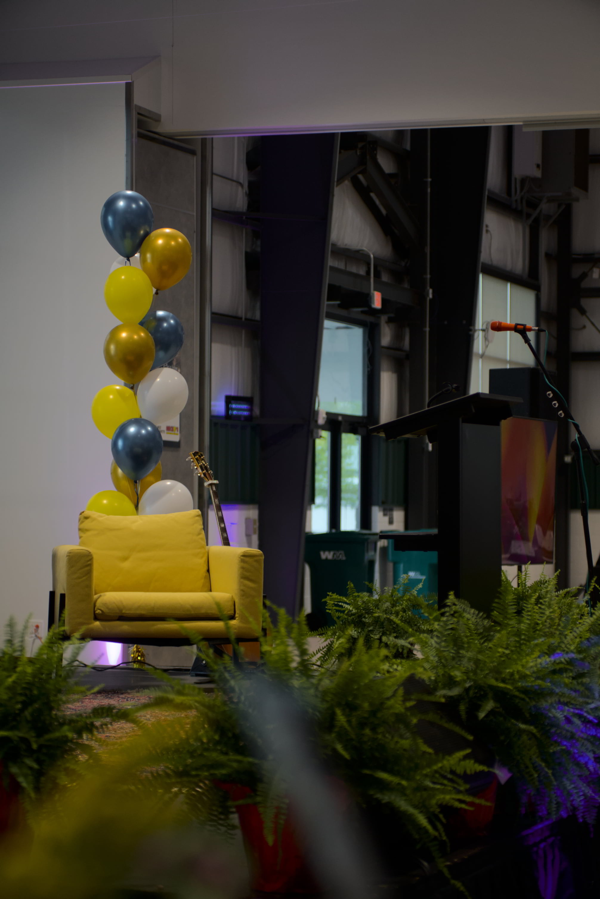 Stage setup with podium, armchair, and balloons